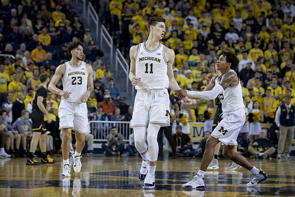 Brandon Johns Jr. (23), Colin Castleton (11), and Eli Brooks (55)