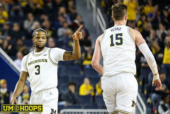 Zavier Simpson (3) and Jon Teske (15)
