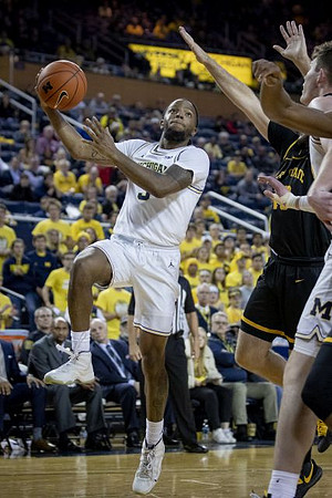Zavier Simpson (3) and Jon Teske (15)