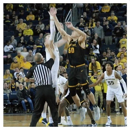 Jon Teske (15), Zavier Simpson (3), and Eli Brooks (55)