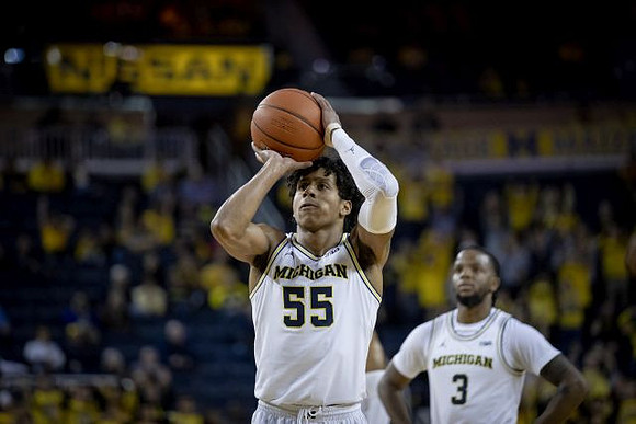 Eli Brooks (55) and Zavier Simpson (3)