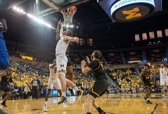 Zavier Simpson (3), Jon Teske (15), and Isaiah Livers (2)