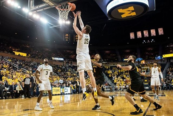 Zavier Simpson (3), Jon Teske (15), and Isaiah Livers (2)