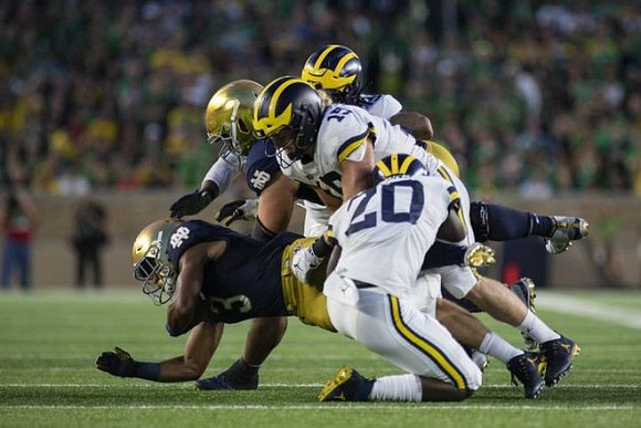Brad Hawkins (20) and Chase Winovich (15)