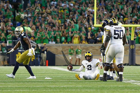 Shea Patterson (2) and Michael Onwenu (50)