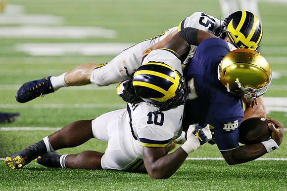 Devin Bush (10) and Chase Winovich (15)