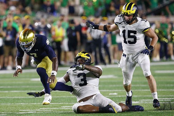 Rashan Gary (3) and Chase Winovich (15)