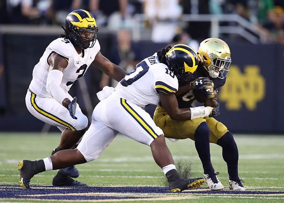 Rashan Gary (3) and Devin Bush (10)