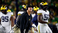 Donovan Jeter (95), Jim Harbaugh, and Michael Dwumfour (50)