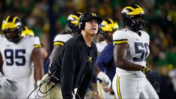 Donovan Jeter (95), Jim Harbaugh, and Michael Dwumfour (50)