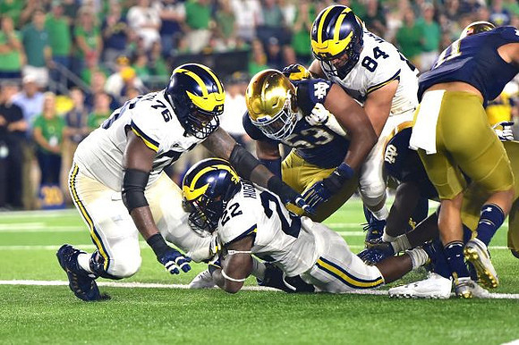 Juwann Bushell-Beatty (76), Karan Higdon (22), and Sean McKeon (84)