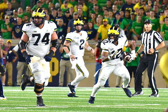 Ben Bredeson (74), Shea Patterson (2), and Chris Evans (12)