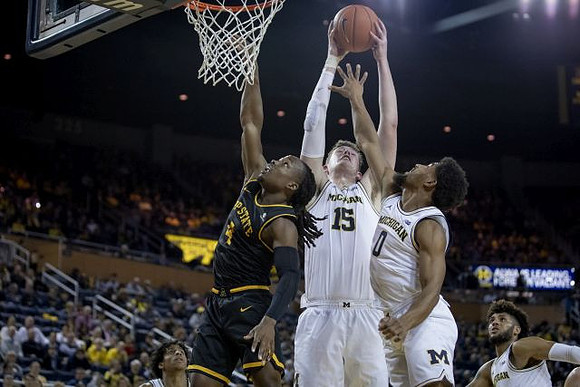 Jon Teske (15), David DeJulius (0), and Isaiah Livers (2)