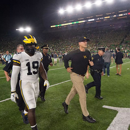 Kwity Paye (19) and Jim Harbaugh