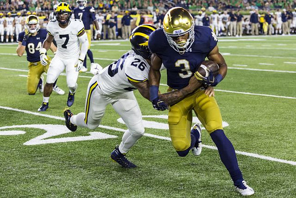 Khaleke Hudson (7) and J'Marick Woods (26)