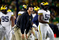 Donovan Jeter (95), Jim Harbaugh, and Michael Dwumfour (50)