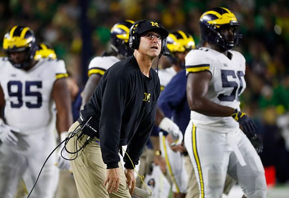 Donovan Jeter (95), Jim Harbaugh, and Michael Dwumfour (50)