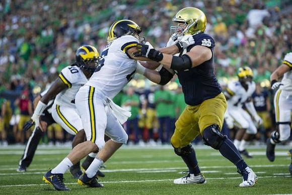 Devin Bush (10) and Chase Winovich (15)