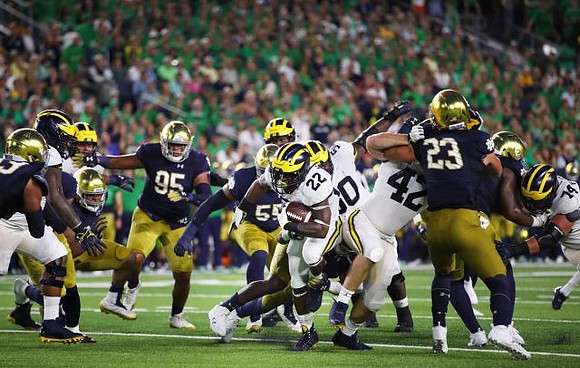 Karan Higdon (22), Michael Onwenu (50), Ben Mason (42), and Ben Bredeson (74)