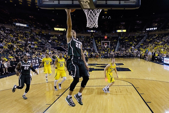 Muhammad-Ali Abdur-Rahkman (12), Zak Irvin (21), and Spike Albrecht (2)