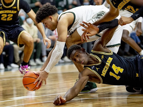 Caleb Houstan (22), Moussa Diabate (14), and DeVante' Jones (12)
