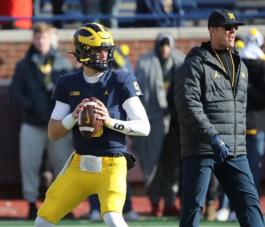 J.J. McCarthy (9) and Jim Harbaugh