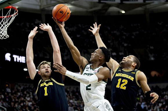 Hunter Dickinson (1) and DeVante' Jones (12)