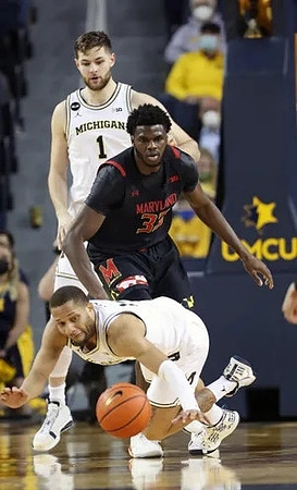 Hunter Dickinson (1) and DeVante' Jones (12)