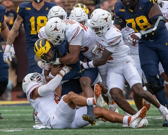 Colston Loveland (18) and Myles Hinton (78)