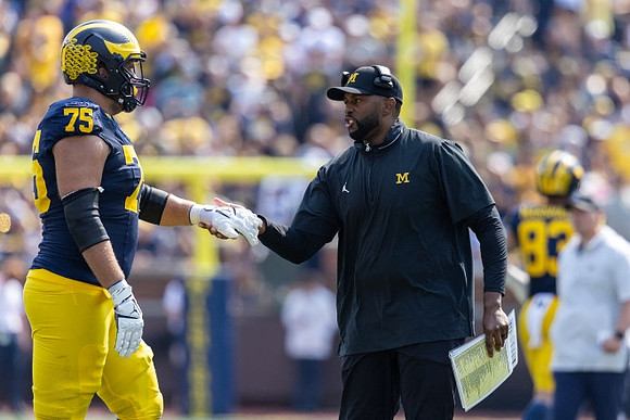 Andrew Gentry (75) and Sherrone Moore