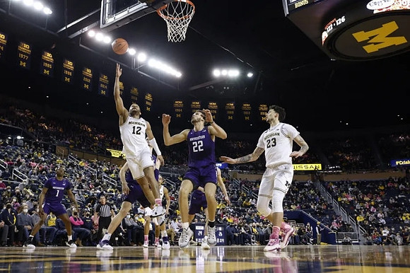 DeVante' Jones (12) and Brandon Johns Jr. (23)