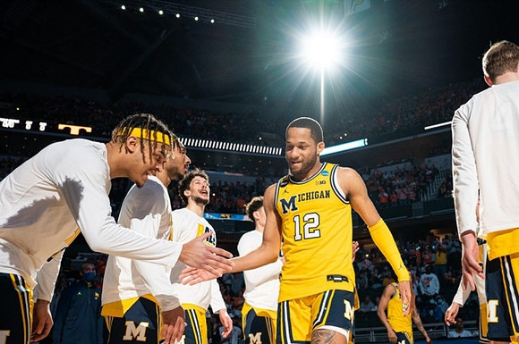 DeVante' Jones (12) and Michigan Team