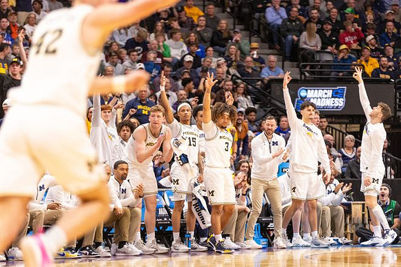 Will Tschetter (42) and Michigan Team
