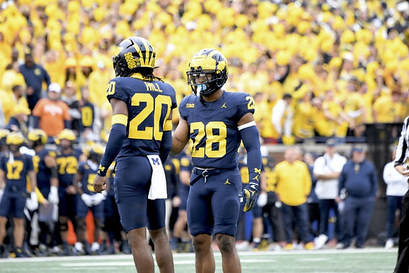 Jyaire Hill (20) and Quinten Johnson (28)