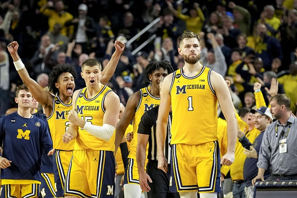 Hunter Dickinson (1) and Michigan Team