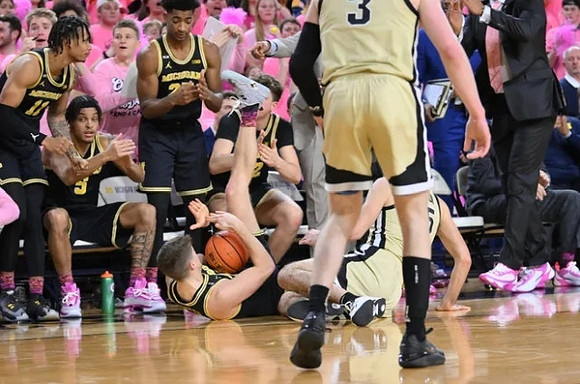 Joey Baker (15) and Michigan Team