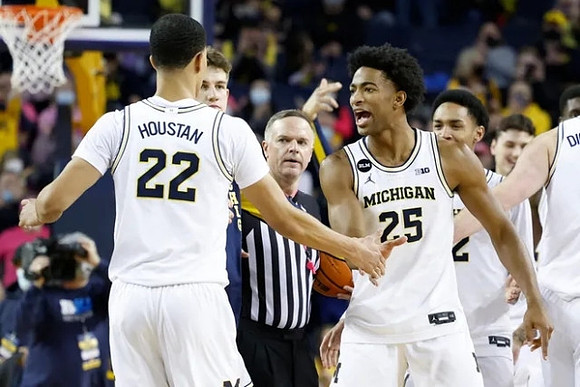 Caleb Houstan (22) and Michigan Team