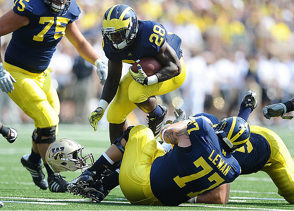 Michael Schofield (75), Fitzgerald Toussaint (28), and Taylor Lewan (77)