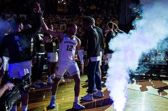 DeVante' Jones (12) and Michigan Team