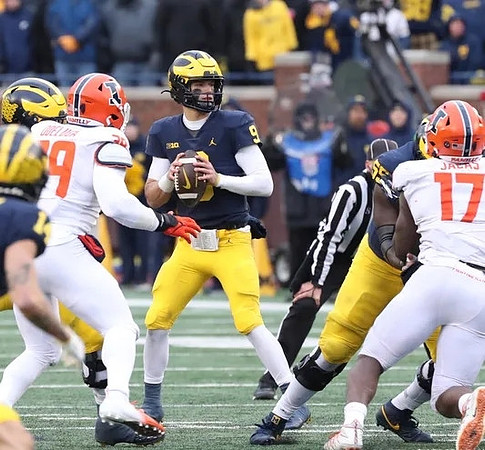 J.J. McCarthy (9) and Olusegun Oluwatimi (55)