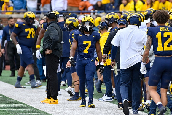 Myles Hinton (78), Sherrone Moore, Donovan Edwards (7), and Kendrick Bell (12)
