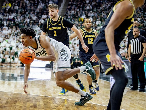 Hunter Dickinson (1) and DeVante' Jones (12)