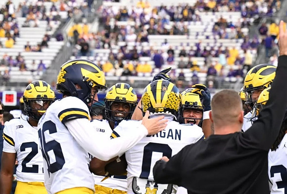 Semaj Morgan (0) and Michigan Team