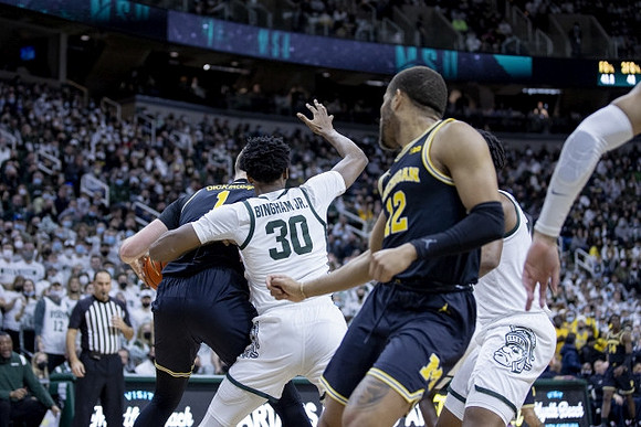 Hunter Dickinson (1) and DeVante' Jones (12)
