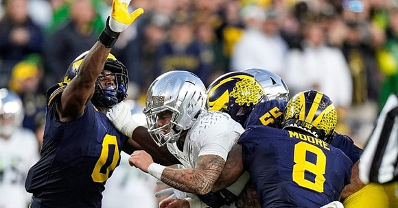 Josaiah Stewart (0), Mason Graham (55), and Derrick Moore (8)