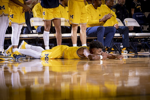 Jace Howard (25) and Michigan Team