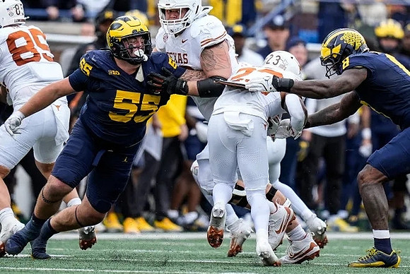 Mason Graham (55) and Derrick Moore (8)