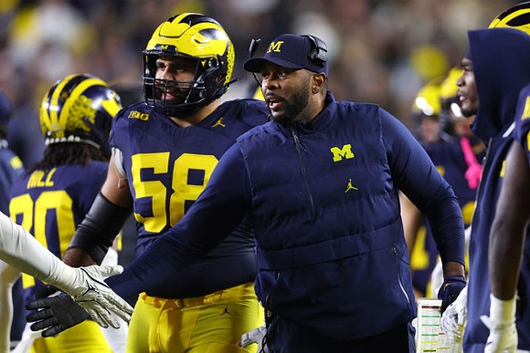 Giovanni El-Hadi (58) and Sherrone Moore
