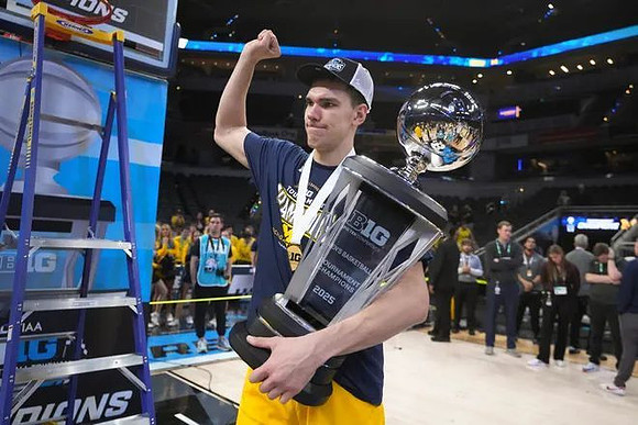 Vladislav Goldin (50) and Big Ten Tournament Championship Trophy