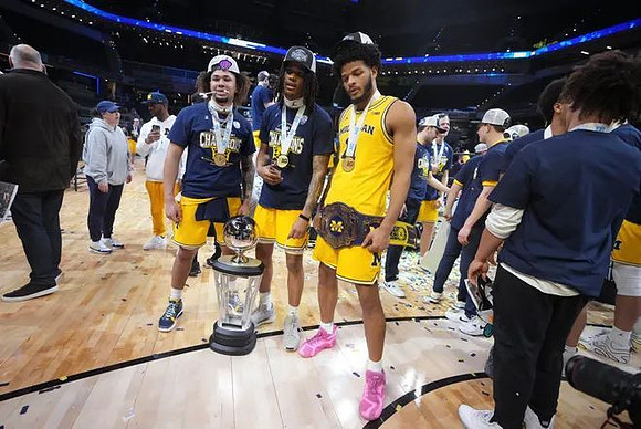 Tre Donaldson (3), Rubin Jones (15), Roddy Gayle Jr. (11), and Big Ten Tournament Championship Trophy